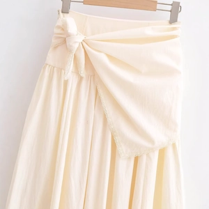 Fashionable cream textured high waist skirt featuring elegant waist tie and lace trim