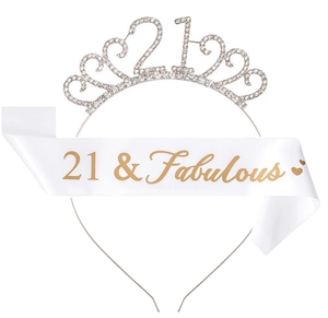 Close-up of silver 21st rhinestone tiara and white 21 & Fabulous sash for party