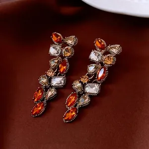 Vintage teardrop rhinestone jewelry set featuring orange crystal tassel earrings