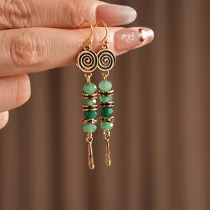 Bohemian beaded teardrop hook earrings featuring green resin beads and gold-tone finish
