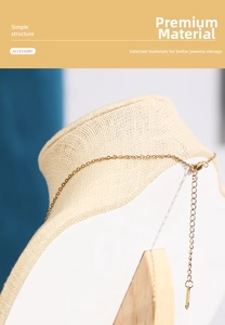 Macro shot of gold necklace lobster clasp and extender chain on linen display