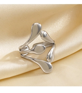 Macro shot of silver irregular water drop ring on champagne satin background