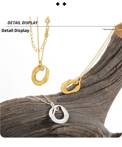Detailed close-up of organic shaped pendants on natural wood with matte finish and gem