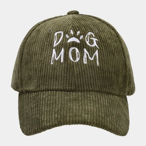 Detail shot of white DOG MOM embroidery and paw print on olive green corduroy baseball cap