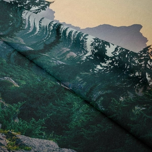 Close-up of the high-quality fabric texture and detailed forest print on a wall tapestry
