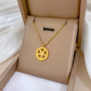 Gold titanium steel necklace with a round heart-carved pendant and center crystal