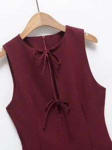 Detail of wine red sleeveless dress showing front lace-up neckline and invisible zipper