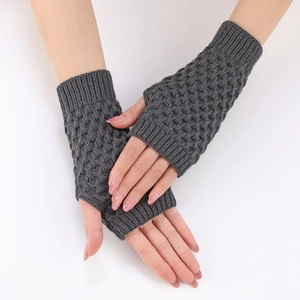 Close-up of grey knitted fingerless gloves with elegant diamond texture pattern
