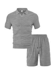 Detail of grey knitted tracksuit with V-neck polo shirt and drawstring shorts