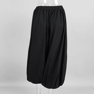 Detailed view of black cotton harem pants with high elastic waist and wide loose cut