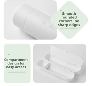 Detail of white plastic pencil box with partitioned design and rounded edges