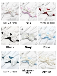 Detailed grid of satin bow sleep masks in nine elegant colors on silk background