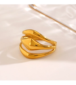 Close-up of golden multi-layer wave ring with high-polished flowing metal texture
