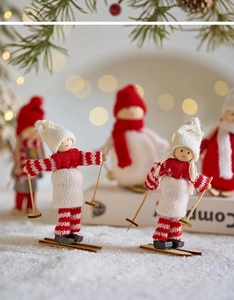 Close-up of wooden Christmas skier figurine with red knit outfit and ski poles