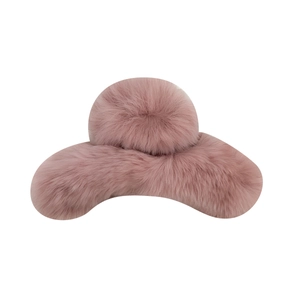 Pink plush faux fur hair claw clip for women with soft texture on white background