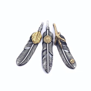 Detailed trio of vintage titanium steel eagle claw feather pendants with turquoise accents