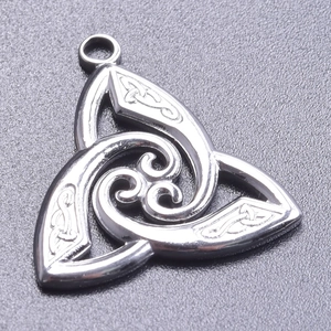Macro shot of silver stainless steel Witch Knot pendant with intricate Celtic engraving