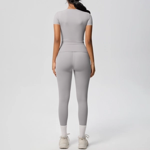 Back view of light grey seamless yoga set showing slim fit athletic crop top and leggings