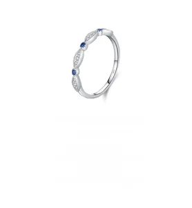 Macro shot of S925 sterling silver ring featuring alternating blue gems and small diamonds