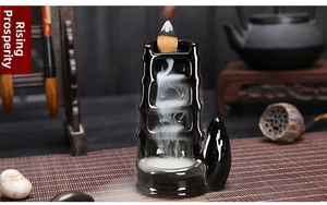 Detail of bamboo shaped ceramic backflow incense burner with flowing smoke effect