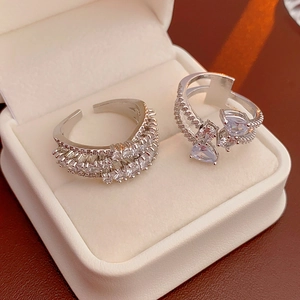 Macro detail of silver adjustable rings featuring cubic zirconia in a jewelry box