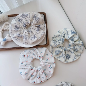 Detailed set of three floral cotton hair scrunchies with elegant botanical patterns