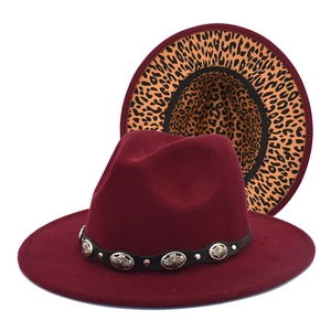 Detail of burgundy wool fedora with metal-studded belt and leopard print brim underside