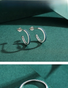 Close-up of S925 silver hoop earrings featuring minimalist inlaid turquoise beads