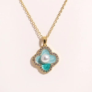 Detail of clover pendant with blue enamel, pearl center and cubic zirconia on gold chain