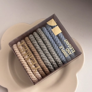 Detail of durable elastic hair ties in a clear gift box on a flower-shaped tray
