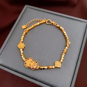 Gold plated vintage Chinese style bracelet with flower and gourd charms on jewelry box