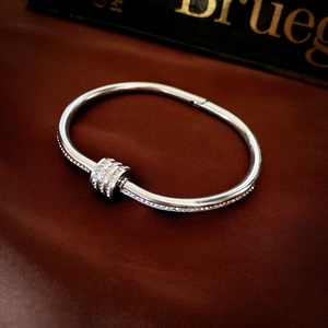Macro shot of polished silver stainless steel bracelet with sparkling micro-pave crystals