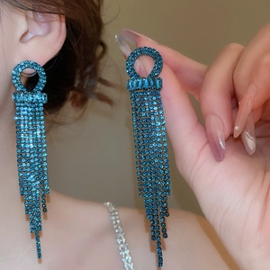 Detail of elegant blue zircon tassel earrings featuring long hanging rhinestone chains