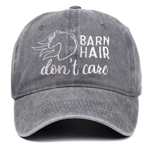 Detailed embroidery of Barn Hair Don't Care lettering on washed gray cotton canvas cap