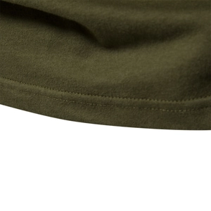 Detailed close-up of double-needle hem stitching on army green cotton knit t-shirt