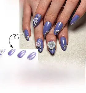 Detail of purple almond press-on nails with 3D white flowers and heart pearl accents