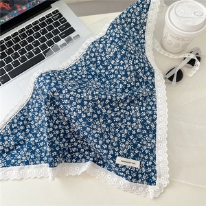 Close-up of blue floral cotton kerchief with delicate white lace trim and 100% cotton tag