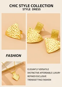 Detail of hammered gold geometric jewelry set showing textured ring and earrings