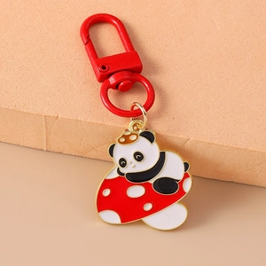 Close-up of cute panda on red mushroom keychain with durable red metal carabiner