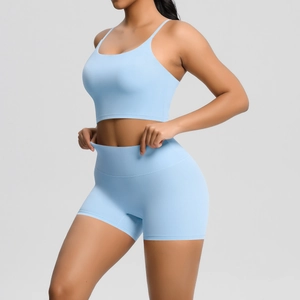 Detail of light blue cross-back sports bra and high-waist shorts set for yoga and fitness