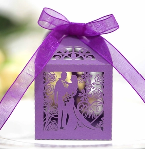Detail of purple laser-cut wedding candy box with Mr & Mrs silhouette and ribbon bow