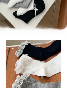 Detail of sweet cotton socks featuring delicate lace trim and ribbon bows in neutral colors