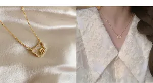 Detail of gold bear pendant with pavé diamonds and m-letter on satin background