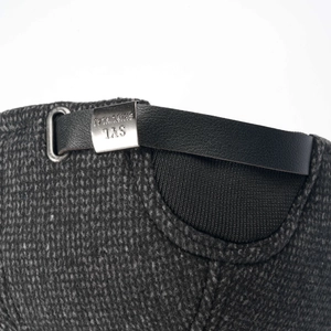 Macro detail of the adjustable leather strap and silver metal buckle on winter baseball cap