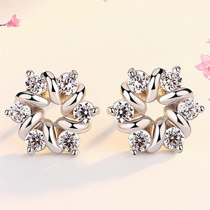 Elegant rotating silver flower stud earrings with sparkling cubic zirconia crystals
