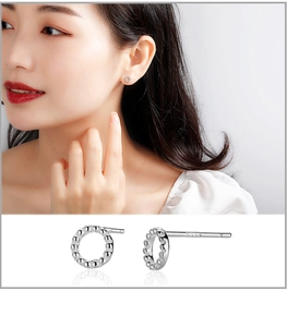 Macro detail of S999 sterling silver hoop earrings with textured bubble design and model view