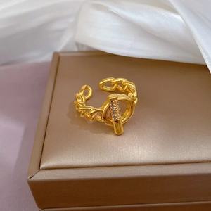 Gold chain toggle ring with micro-set diamonds on a luxury jewelry box display
