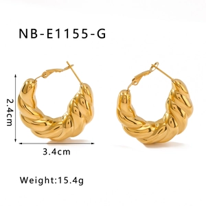 Detail view of gold croissant hoop earrings with 2.4cm height and 3.4cm width dimensions