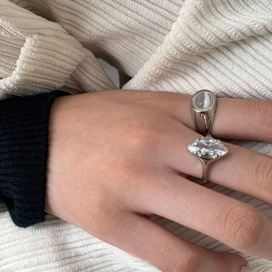 Silver signet ring and marquise-cut zircon ring set worn on model's hand