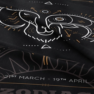 Detail of Aries zodiac tapestry showing fine fabric texture and golden celestial print